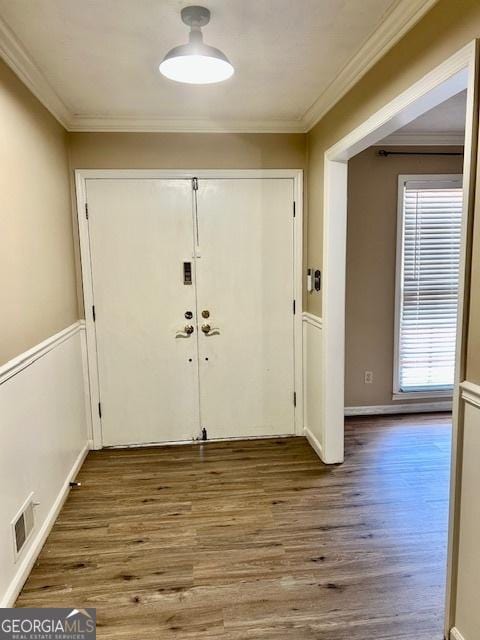 entryway featuring ornamental molding and hardwood / wood-style floors