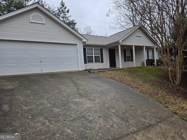 ranch-style home featuring a garage and a front yard