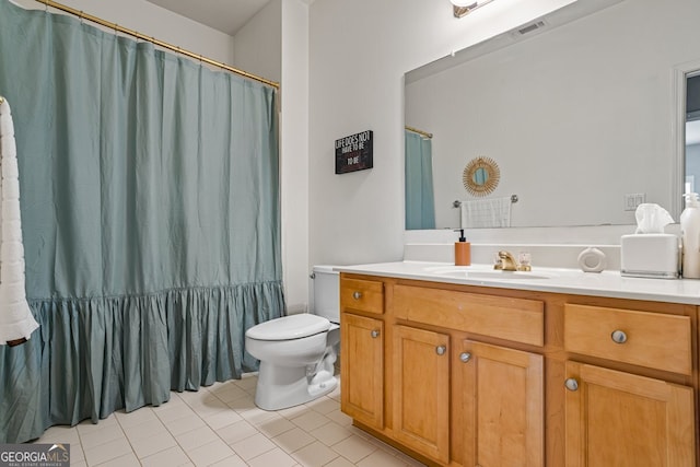 bathroom featuring vanity, tile patterned flooring, and toilet