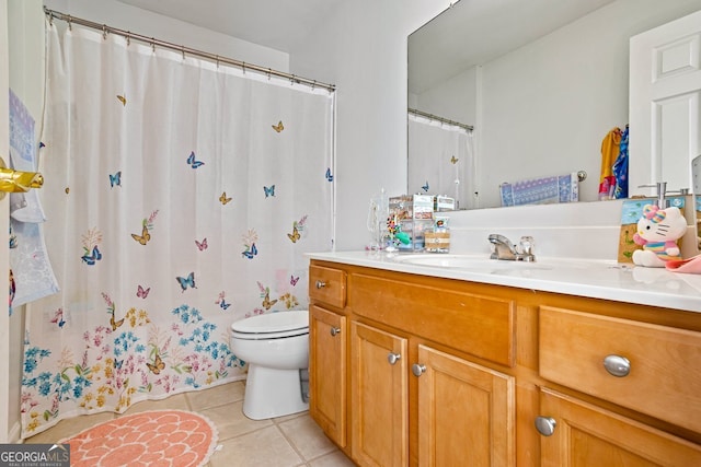 bathroom with vanity, tile patterned floors, and toilet