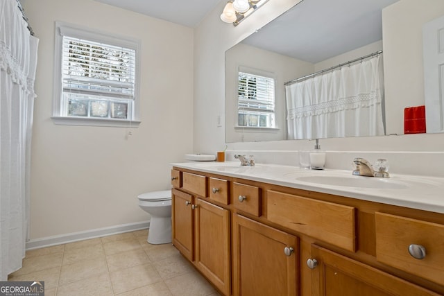 bathroom with tile patterned floors, vanity, and toilet