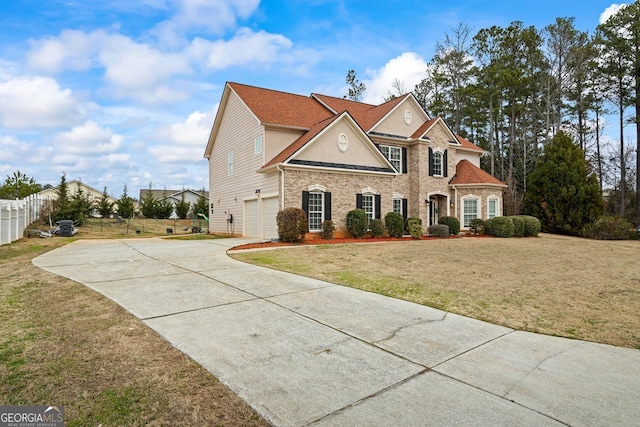 view of front facade with a garage and a front yard