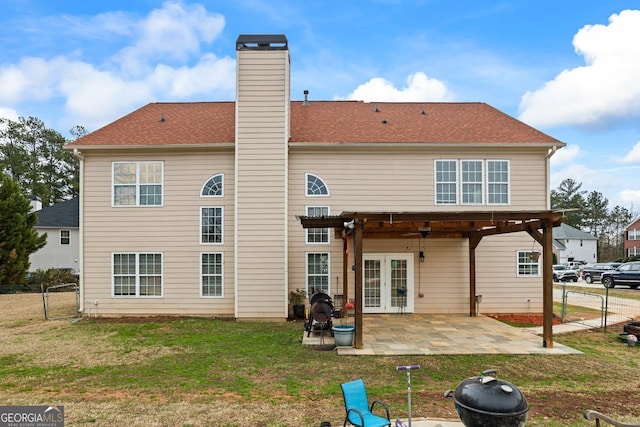 back of property with a patio, a lawn, and a pergola