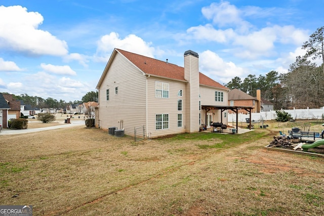 rear view of property featuring a patio, central AC unit, and a lawn