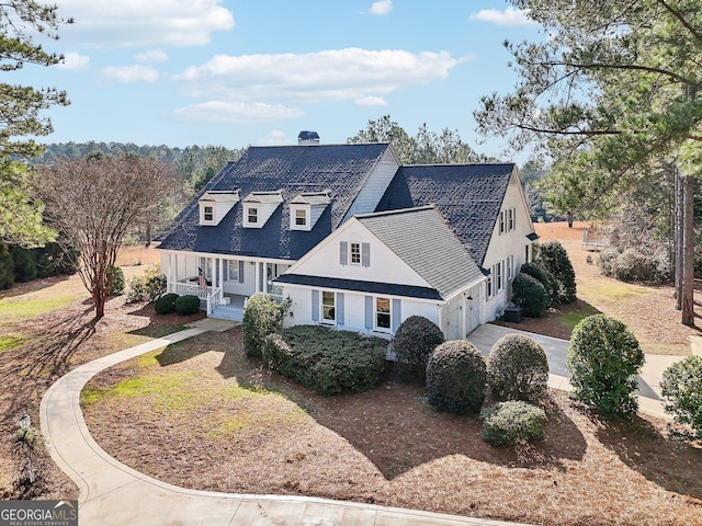 cape cod home featuring a porch