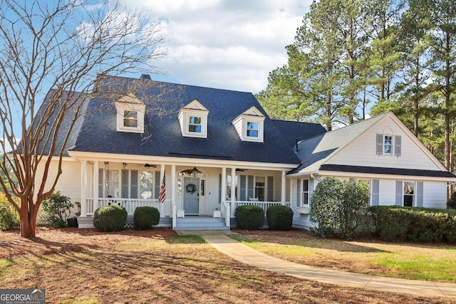 cape cod-style house with covered porch