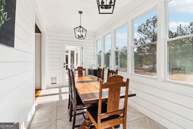 sunroom / solarium with an inviting chandelier