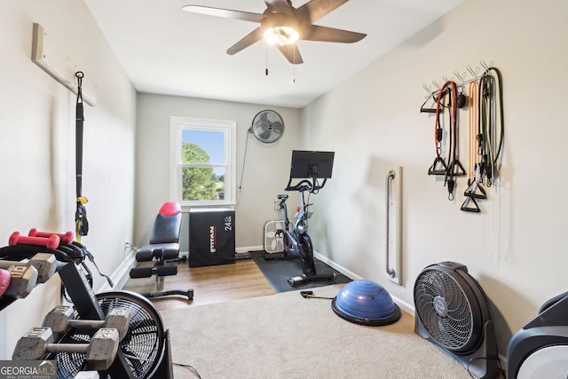 workout area featuring ceiling fan and light hardwood / wood-style flooring