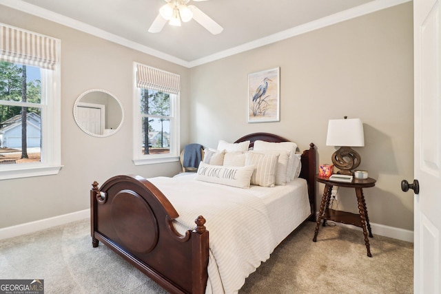 carpeted bedroom featuring multiple windows, ornamental molding, and ceiling fan