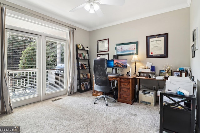 home office featuring light carpet, ornamental molding, and ceiling fan