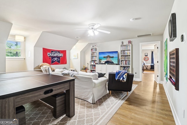 living room with light hardwood / wood-style floors and ceiling fan