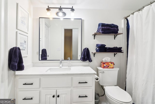 bathroom with vanity, toilet, and a shower with shower curtain