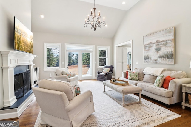 living room featuring an inviting chandelier, dark hardwood / wood-style floors, and high vaulted ceiling