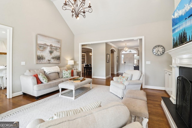 living room with dark wood-type flooring, an inviting chandelier, and high vaulted ceiling