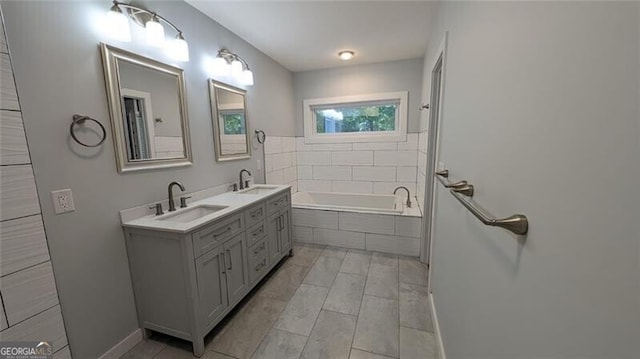 bathroom featuring vanity and tiled bath