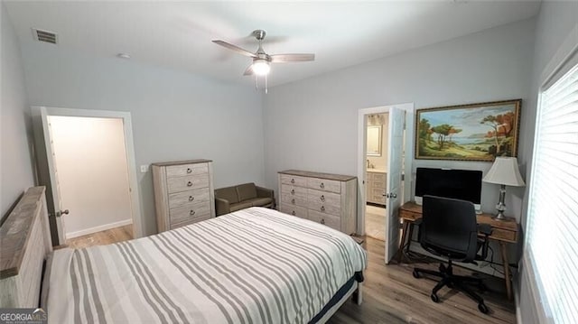 bedroom with ceiling fan, ensuite bathroom, and light hardwood / wood-style floors