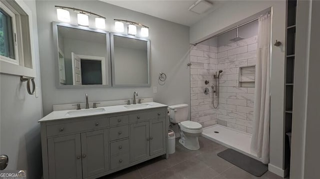 bathroom with tile patterned flooring, toilet, vanity, and walk in shower