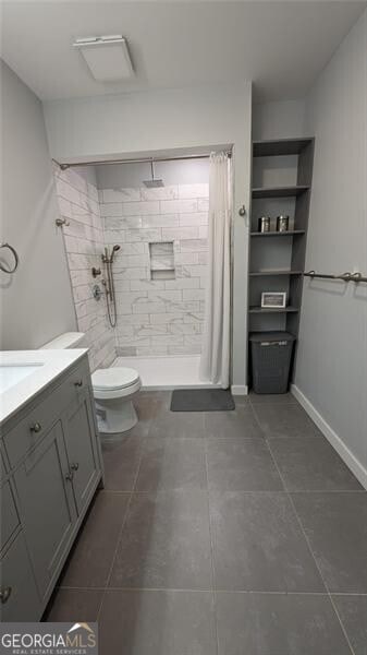 bathroom with vanity, tile patterned flooring, a shower with curtain, and toilet