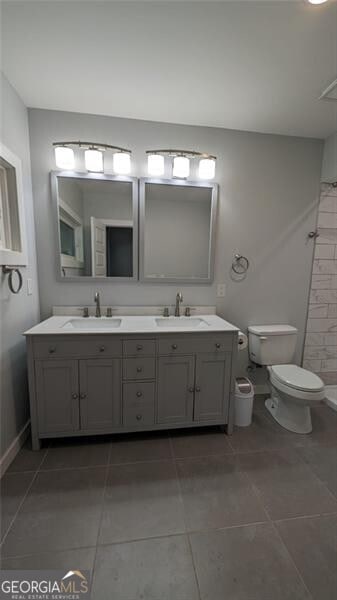 bathroom with vanity, toilet, and tile patterned flooring