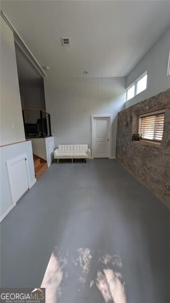 unfurnished living room featuring concrete flooring