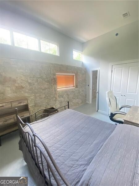 bedroom featuring a towering ceiling