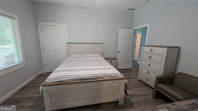 bedroom featuring lofted ceiling and dark hardwood / wood-style floors