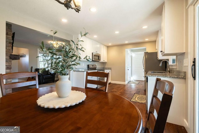 dining room with dark hardwood / wood-style flooring and sink