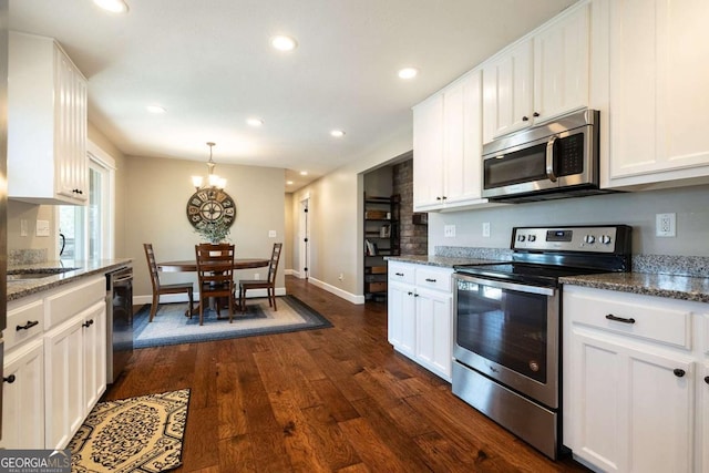 kitchen with white cabinetry, stainless steel appliances, dark hardwood / wood-style flooring, and dark stone countertops