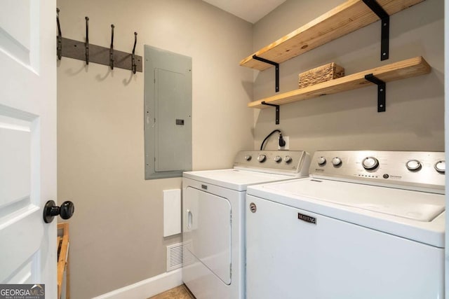 washroom with electric panel and washing machine and clothes dryer