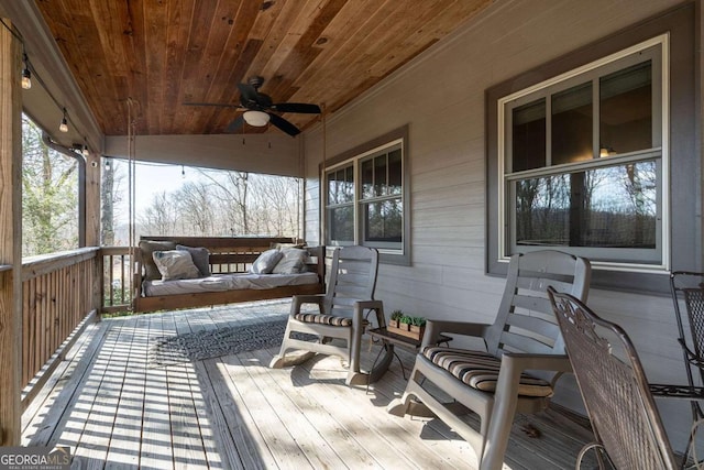 wooden deck with a porch, an outdoor hangout area, and ceiling fan