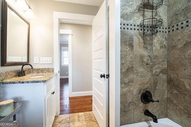 bathroom with vanity and tiled shower / bath