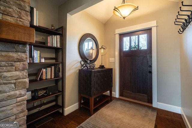 entryway featuring lofted ceiling and dark hardwood / wood-style floors