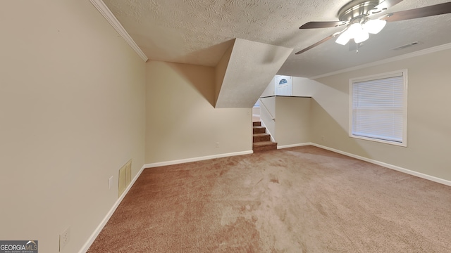 bonus room featuring ceiling fan, a textured ceiling, and carpet