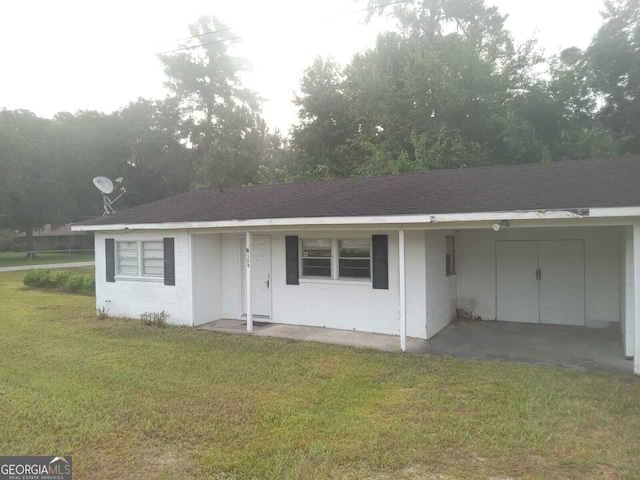 ranch-style home with a front lawn and a carport