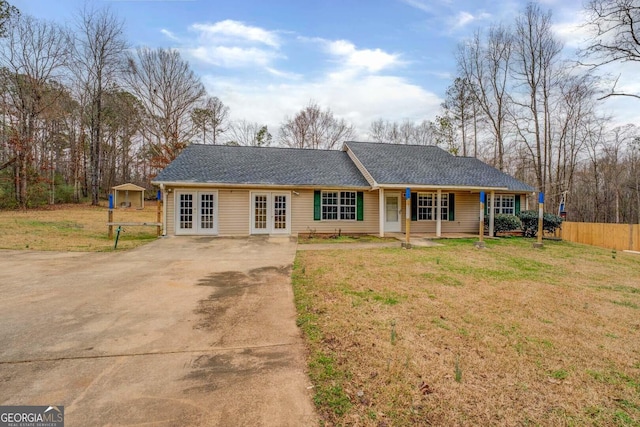 single story home with a front lawn and french doors