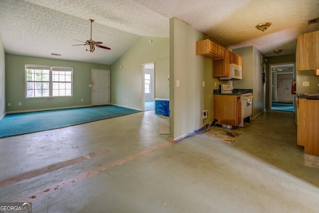 kitchen with white appliances, vaulted ceiling, concrete floors, a textured ceiling, and ceiling fan