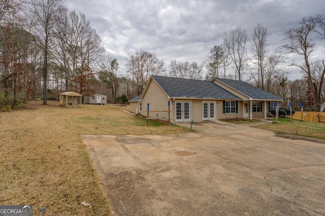 view of property exterior with a shed and a lawn