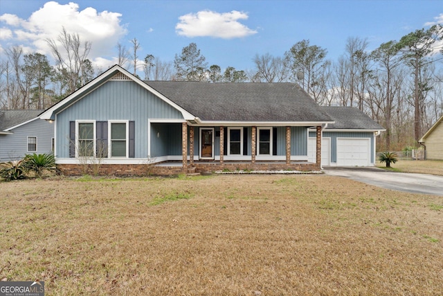 single story home featuring a garage, covered porch, and a front yard