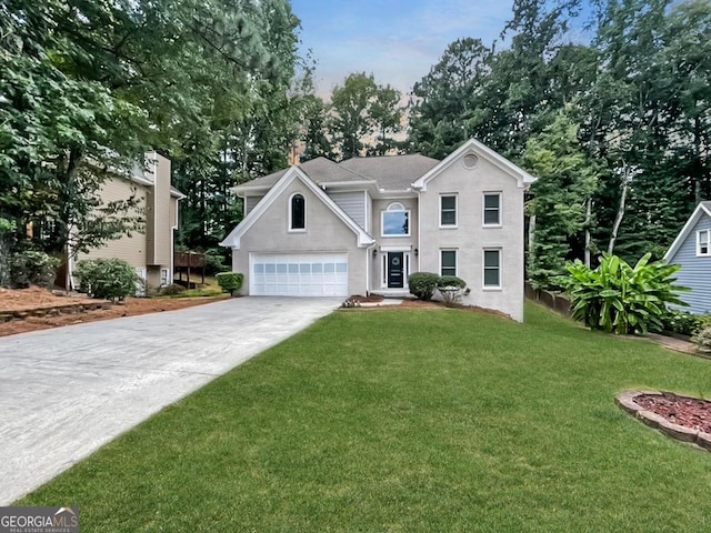 view of front of property featuring a garage and a front yard