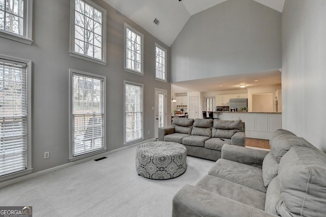 carpeted living room with lofted ceiling