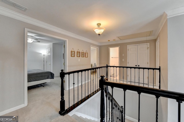 hall featuring ornamental molding and light carpet