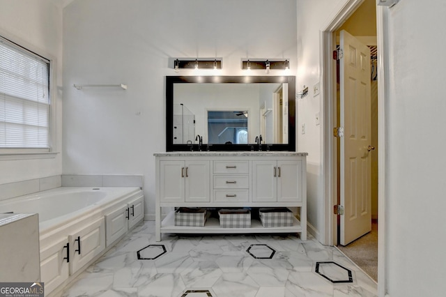 bathroom with vanity and a tub