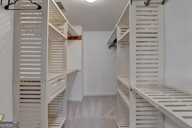 spacious closet featuring light carpet