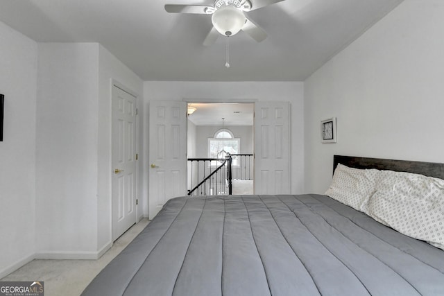 unfurnished bedroom featuring light colored carpet and ceiling fan