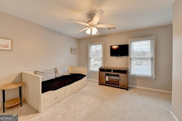 interior space featuring light carpet and ceiling fan