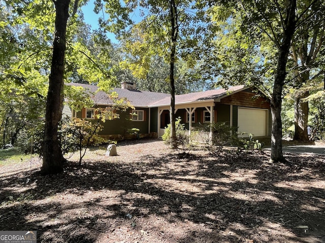 ranch-style house with a garage and covered porch