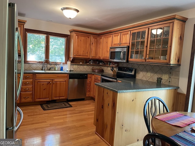31 Hilltop Dr, Hayesville, NC 28904 - kitchen featuring appliances with stainless steel finishes, light hardwood / wood-style floors, sink, and kitchen peninsula