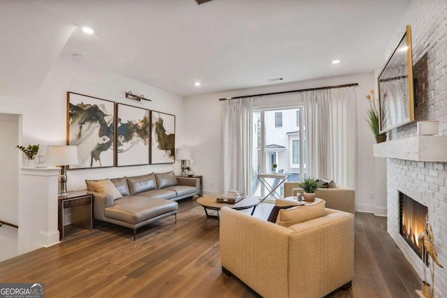 living room with a fireplace and dark hardwood / wood-style flooring