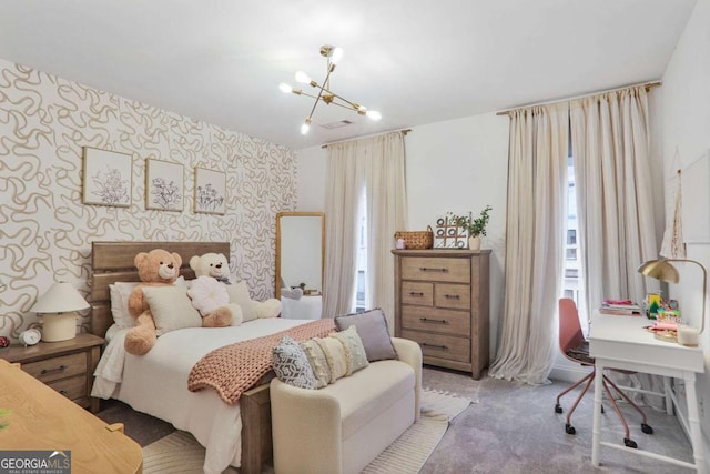 carpeted bedroom featuring wallpapered walls and an inviting chandelier