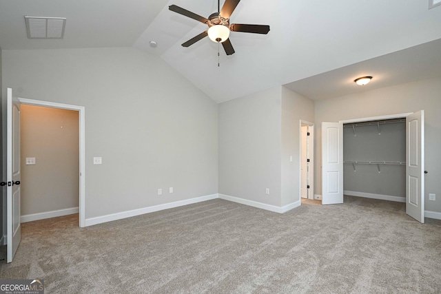 unfurnished bedroom featuring ceiling fan, light carpet, a closet, and lofted ceiling